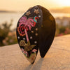 Hand-embroidered tropical bird headband with sequins and crystals on rich black satin base