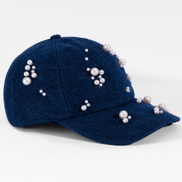 Blue cap with pearl embellishments on a white background