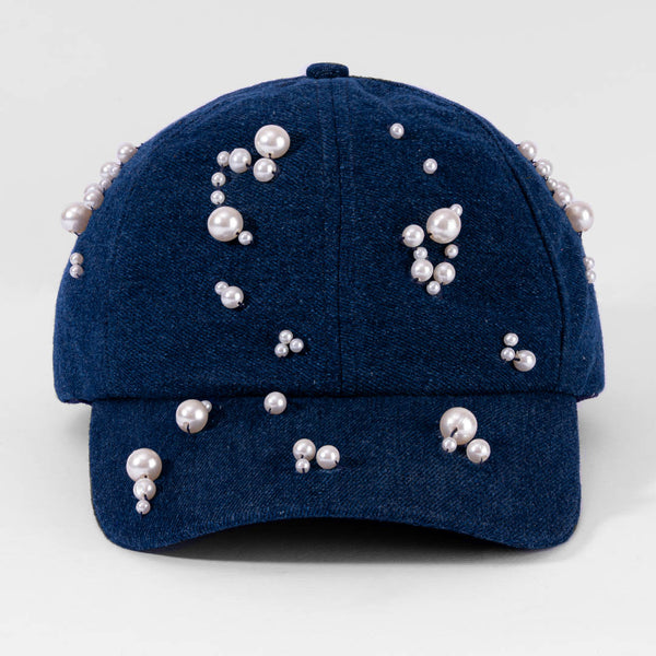 Blue cap with pearl embellishments on a light gray background