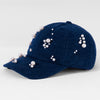Navy blue cap with pearl embellishments on a light gray background