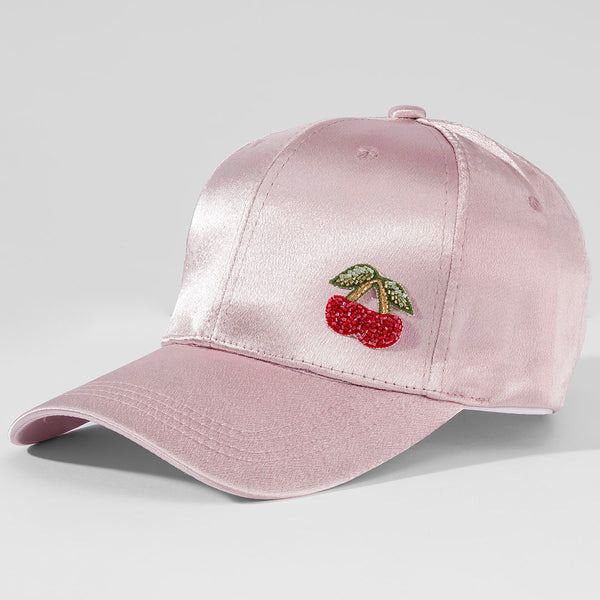 Pink satin cap with cherry embroidery on a light gray background