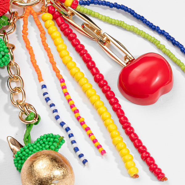 Colorful beaded keychains with various charms on a white background
