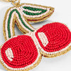 Beaded cherry keychain with red, green, and gold colors on a light background