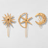 Three gold brooches with star, moon, and sun designs on a light gray background
