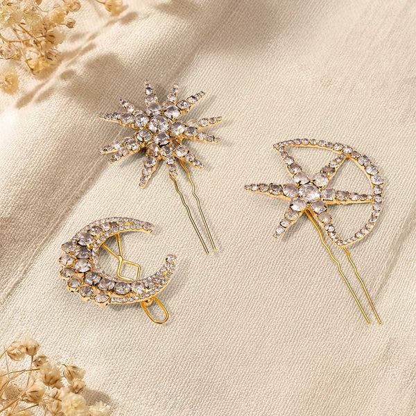 Three decorative hair pins with gemstones on a beige background