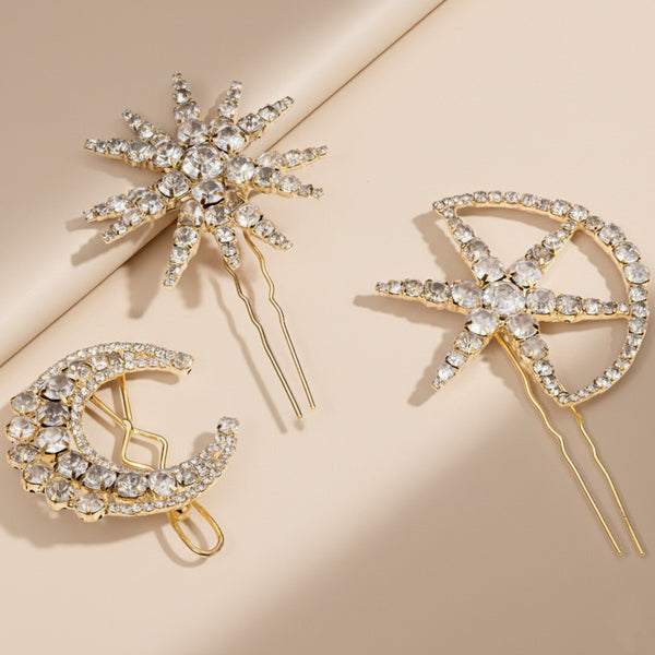 Three decorative hair pins with gemstones on a beige background