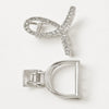 A silver-toned hair claw clip shown from two angles on a clean white background. One view shows the front with a curved open design set with clear rhinestones, and the other shows the back with a D-shaped frame and spring-loaded clasp mechanism.