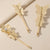 Gold butterfly hair pins on a beige background