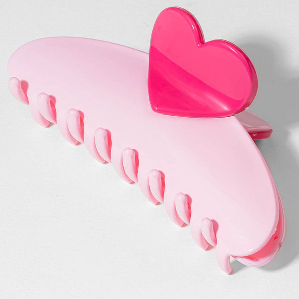 Pink heart-shaped hair clip on a light gray background