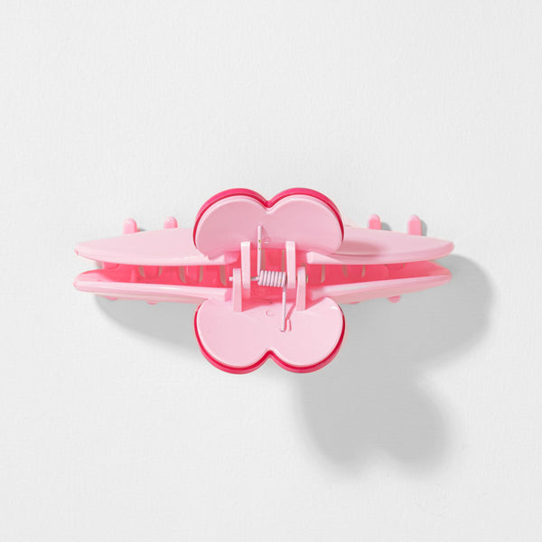 Pink heart-shaped hair clip on a light gray background