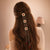 Gold Plated Circular Hair Braid with Maroon Stones