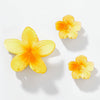 Three yellow flower-shaped objects on a white background