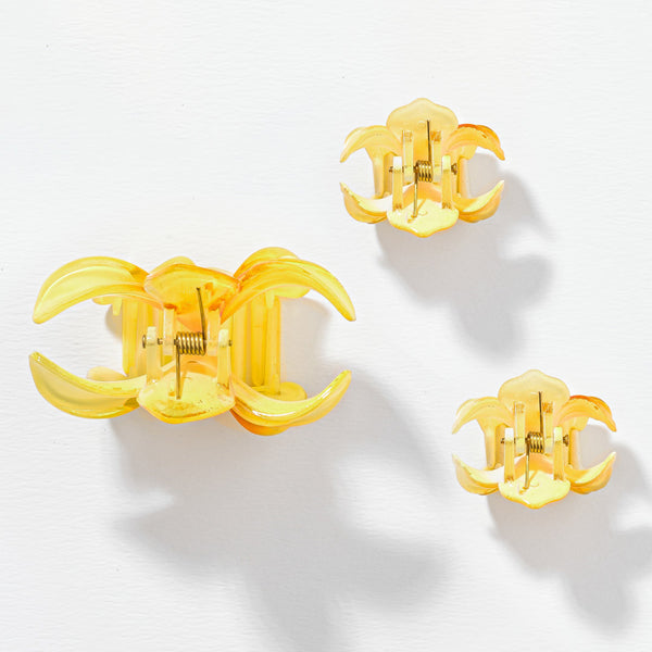 Gold earrings with a clear 'CC' design on a white background