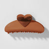 Brown heart-shaped hair clip on a light gray background