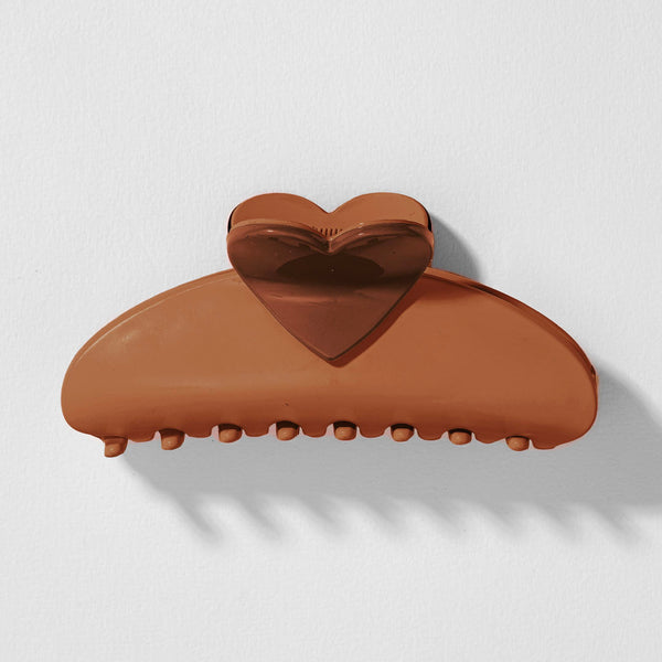 Brown heart-shaped hair clip on a light gray background