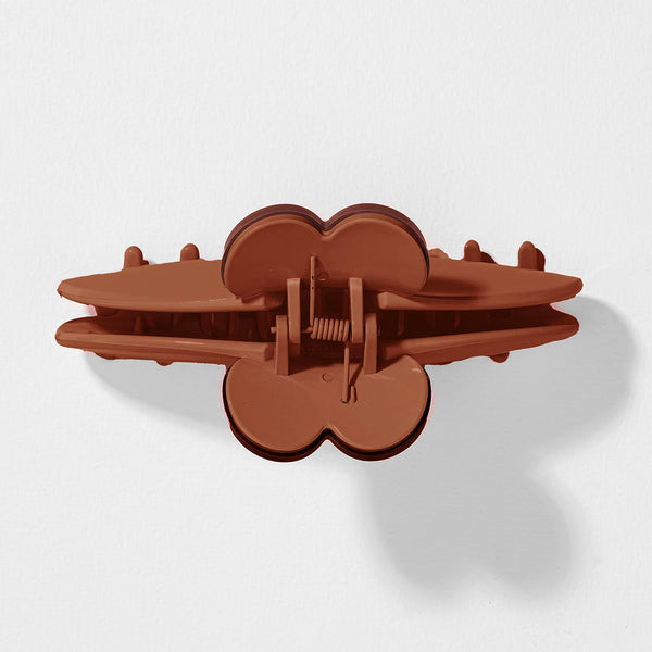 Brown plastic clip on a white background