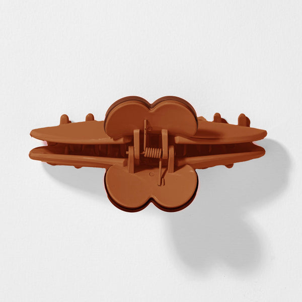 Brown plastic clip on a white background