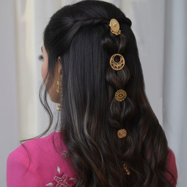 Woman with styled hair featuring decorative hairpins against a neutral background