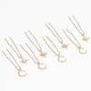 Delicate gold star moon pins scattered through soft updo hairstyle for sufi night celebration