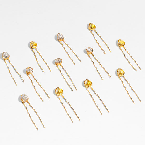 Mixed metal crystal hair pins in yellow-gold and silver colors scattered through wavy hair