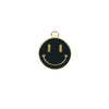A small metal charm featuring a black smiley face with gold-colored accents and details.