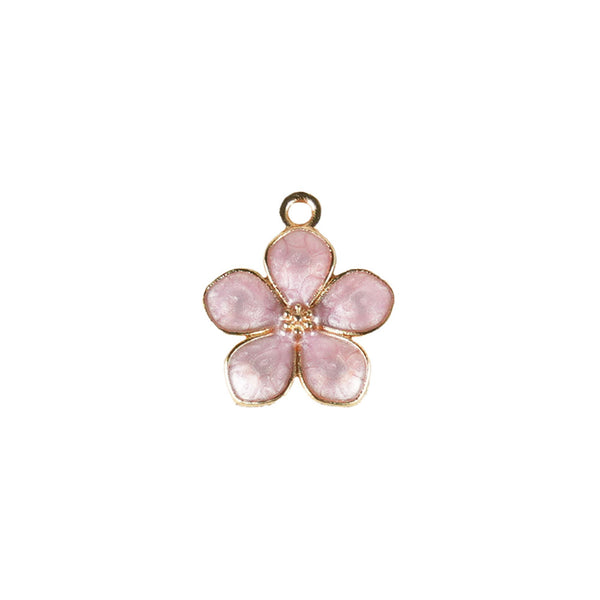A small metal hair charm shaped like a purple flower with a gold-colored outline.
