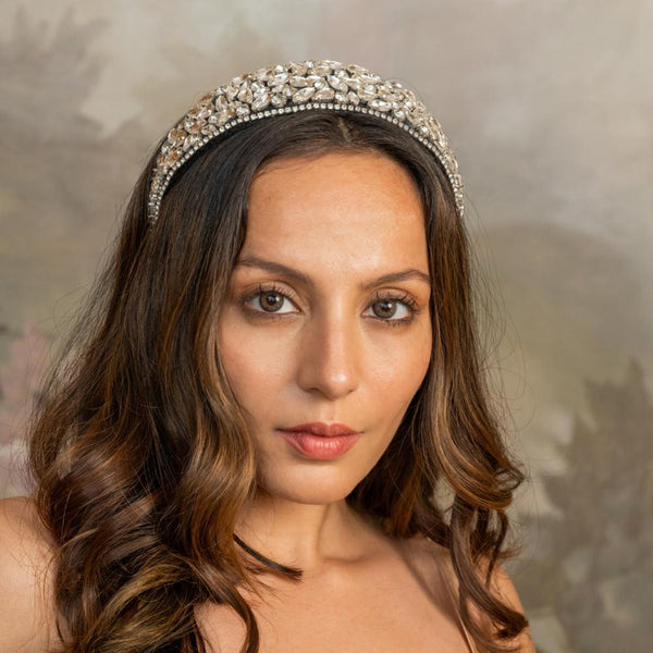 A woman wearing a silver flat hair band adorned with crystals.