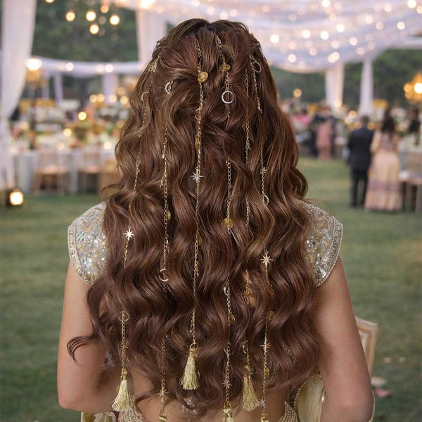 Woman with long, wavy hair adorned with decorative hair accessories at an outdoor event.