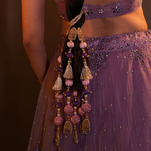 Festive hair parandi featuring layered pearls, crystals, tassels and soft ghungroo accents