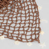 Brown boho crochet headband with dangling shell charms for beach hair and festival outfits