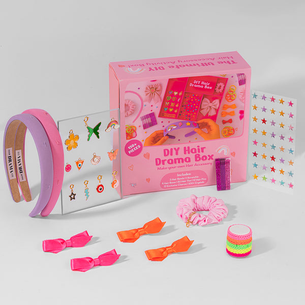 DIY Hair Drama Box with hair accessories on a light gray background