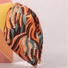 Decorative headband with colorful pattern and beads on a white background