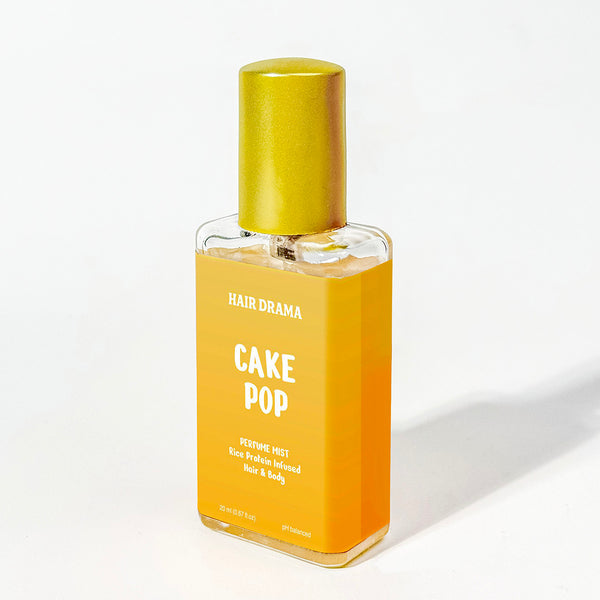 Hair drama cake pop product bottle with yellow cap on a white background