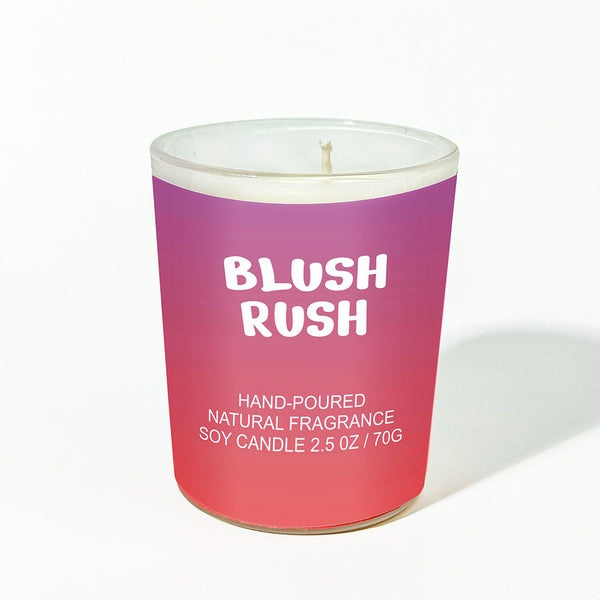 Candle with 'Blush Rush' text on a gradient purple and pink container