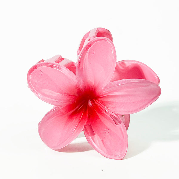 Pink flower-shaped hair clip on a white background