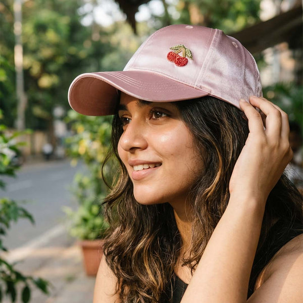 Lustrous pink satin baseball cap featuring hand-stitched cherry motif - adjustable fit