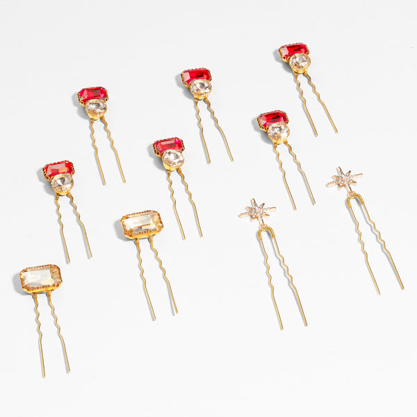 Ruby crystal pins with silver star accents styled along sleek bun