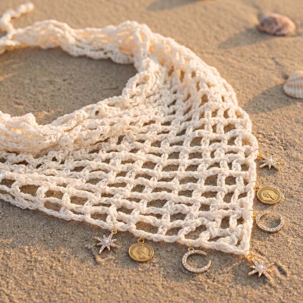 Off-white hair wrap with star and moon charms dangling, boho crochet headscarf for beach days