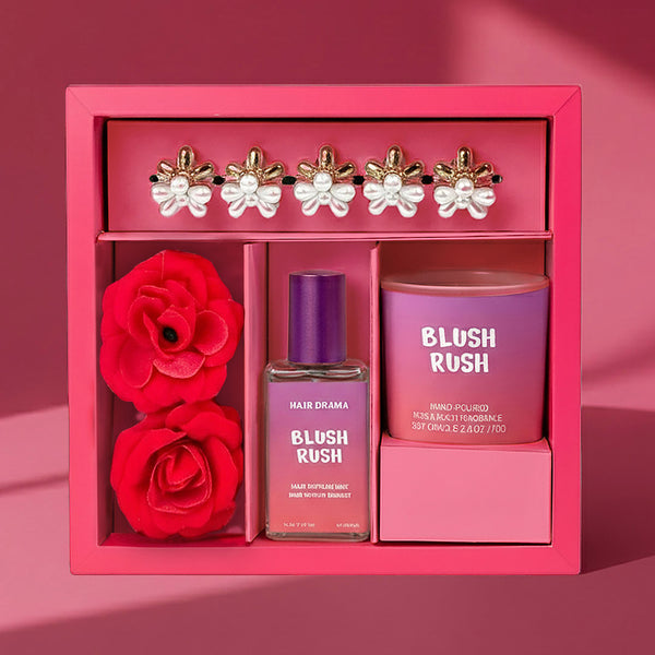 Pink gift set with 'Blush Rush' perfume and hair product, red roses, and decorative earrings.