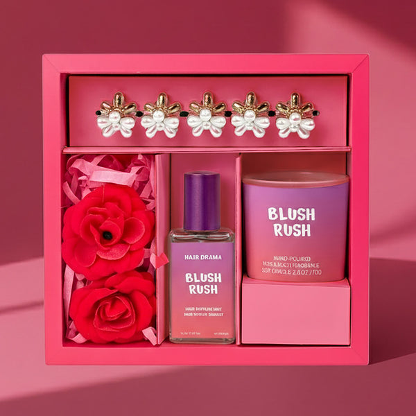 Pink gift set with 'Blush Rush' perfume and hair product, red roses, and decorative earrings.