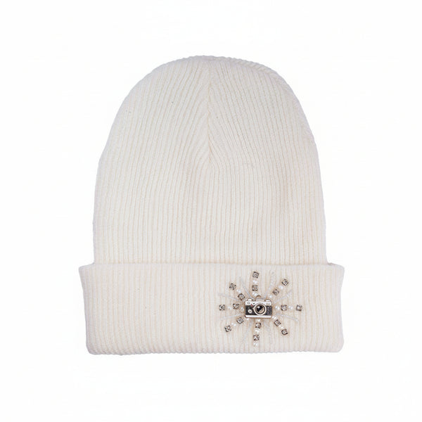 White beanie with decorative emblem on a white background