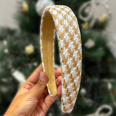 A brown houndstooth puff hair band with a heart charm, branded with 'Hair Drama Co. Emily in Paris'.