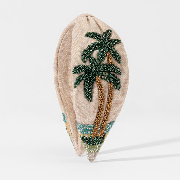 Hand-beaded tropical headband with emerald palm trees and gold sequin sand on beige linen base