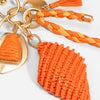 Orange beaded keychain with gold heart charm on a white background
