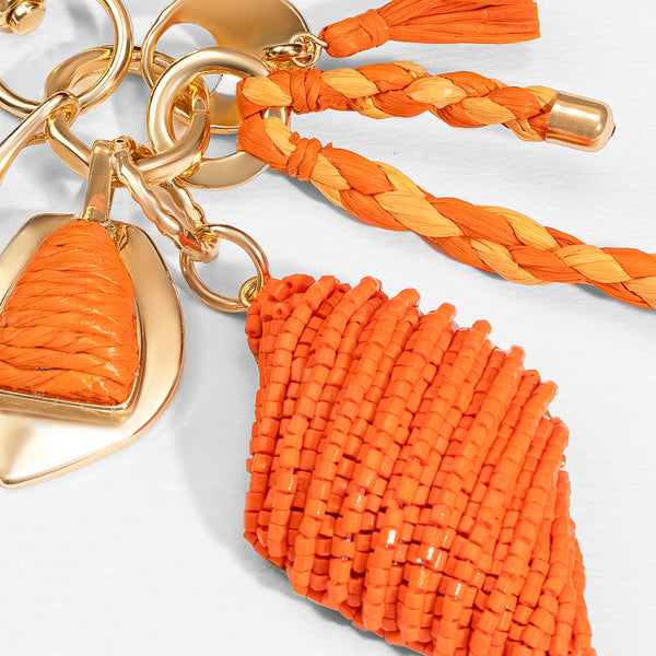 Orange beaded keychain with gold heart charm on a white background