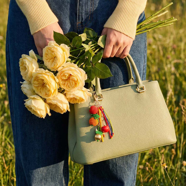 Colourful fruit bag accessory featuring shiny bead accents and secure metal clip attachment