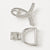 A silver-toned hair claw clip shown from two angles on a clean white background. One view shows the front with a curved open design set with clear rhinestones, and the other shows the back with a D-shaped frame and spring-loaded clasp mechanism.