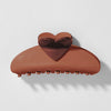 Brown heart-shaped hair clip on a light gray background