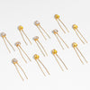 Mixed metal crystal hair pins in yellow-gold and silver colors scattered through wavy hair