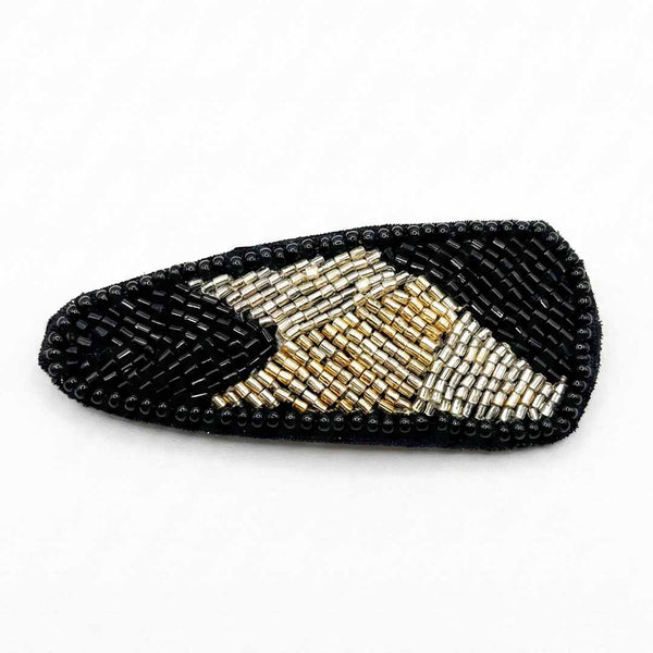 Black and gold beaded sandal on a white background